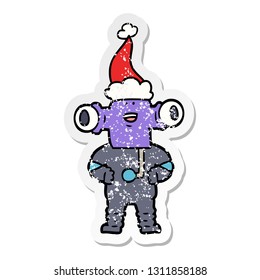 friendly hand drawn distressed sticker cartoon of a alien wearing santa hat