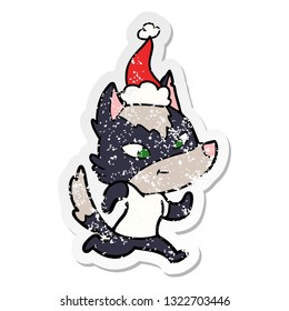 friendly hand drawn distressed sticker cartoon of a wolf wearing santa hat