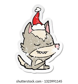 friendly hand drawn distressed sticker cartoon of a wolf sitting wearing santa hat