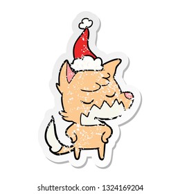 friendly hand drawn distressed sticker cartoon of a fox wearing santa hat