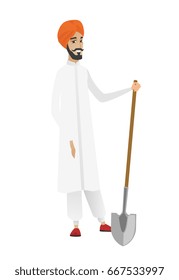 Friendly hindu farmer standing with a shovel. Full length of young farmer in headscarf holding a shovel. Gardener with a spade. Vector flat design illustration isolated on white background.