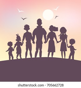 Friendly large family standing in the background of a sunset holding hands