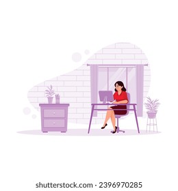 Friendly mature woman working in a modern office. He uses a computer while working in the office. Office concept. Trend Modern vector flat illustration