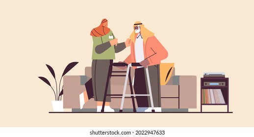 Friendly Nurse Or Volunteer Supporting Arab Elderly Man With Walkers Home Care Services Healthcare