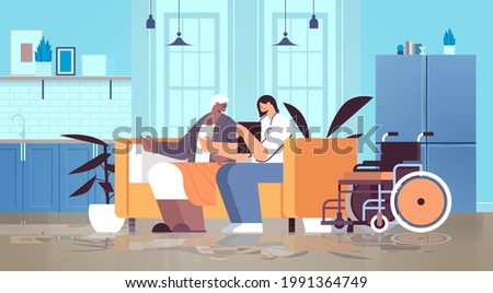 friendly nurse or volunteer supporting elderly woman home care services healthcare and social support