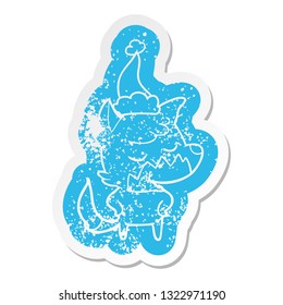 friendly quirky cartoon distressed sticker of a fox wearing santa hat