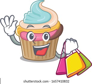 A friendly rich rainbow cupcake waving and holding Shopping bag