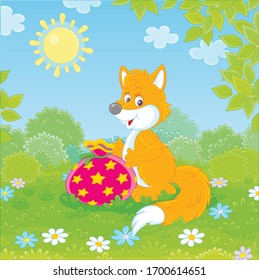 Friendly smiling red fox holding a beautiful bag with a holiday gift on green grass of a pretty forest glade on a sunny summer day, vector cartoon illustration