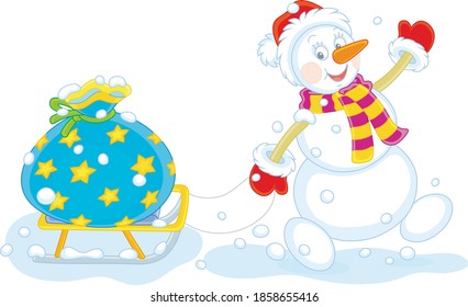 Friendly smiling snowman with a red hat, a warm scarf and mittens carrying a big bag of winter holiday gifts on a toy sledge, vector cartoon illustration isolated on a white background