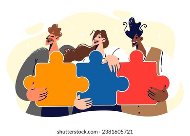 Friendly team of people holding colorful puzzles with smile, assembled thanks to collaboration and coworking. Woman and two men recommend becoming one team to achieve success and company goals