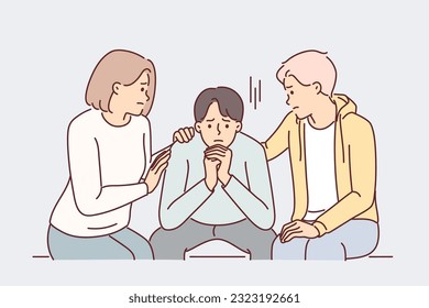 Friends console depressed man suffering from stress after breaking up with girlfriend or being fired from job. Friends support and provide moral assistance for guy who is in difficult life situation.