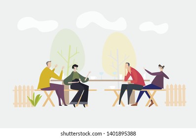 Friends in the park having a star and drinks and discussing the last news. Socialising concept, modern every day life
