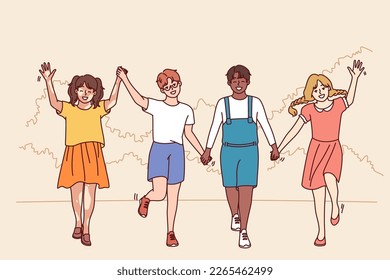 Friends teenagers diversity nationalities and races walk in park holding hands enjoying friendship and spending summer holidays together. Multiethnic boys and girls for concept diversity in society 