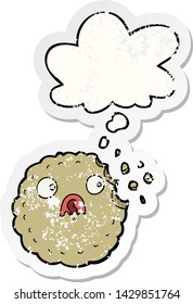 frightened cookie cartoon with thought bubble as a distressed worn sticker