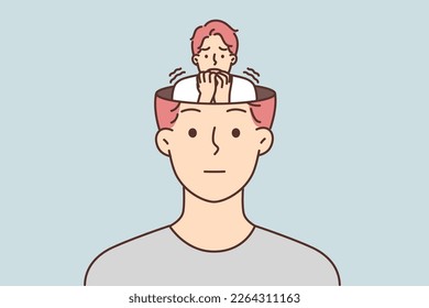 Frightened human sits in head of calm man hiding fear and emotions from others. Frightened guy experiences internal panic but does not want to show personal problems