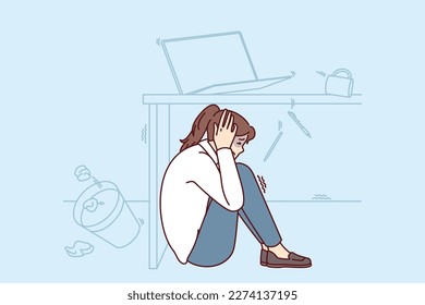 Frightened woman wait out earthquake hiding under office desk to save herself during building collapse. Girl sits on floor fleeing earthquake or tornado and other natural anomalies