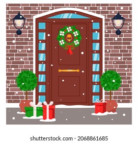 Front Door Is Decorated With Festive Decor For Christmas And New Year. Brick Wall, Lamps, Wreath, Gift Boxes And Snow. Vector Illustration In Flat Style