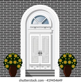 front door to the house decorated with potted flowers