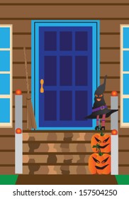 Front step entrance to a home with pumpkins, witch, and broom