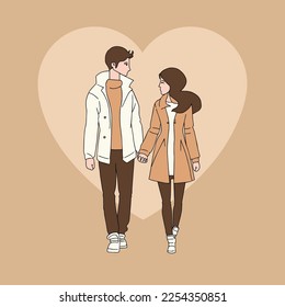 Front view of a couple holding hands in winter clothes on valentines day