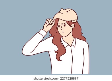Frowning woman removes mask from face designed to hide identity or show fake emotions. Mask metaphor of lies and hypocrisy for purpose of fraud or obtaining insider information in business 