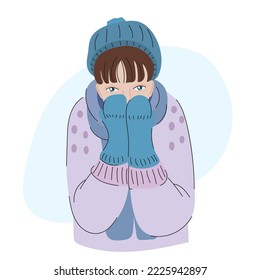 Frozen girl in winter clothes. Woman hides her face in mittens. Sick woman. Person in a hat, mittens, sweater