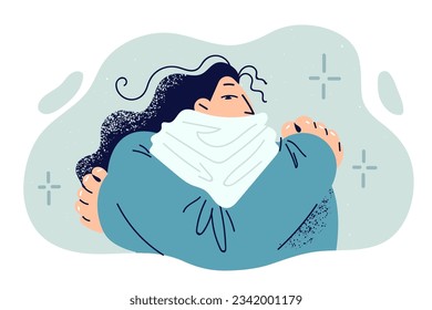 Frozen woman is shivering from cold and hugs herself trying to keep warm, dressed in sweater and scarf hiding neck. Frozen tortured girl feels chills after returning from winter street