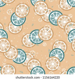 Fruit pattern with lemon and lime, ice cubes and mint leaves on a blue background. Cold cocktail with lemon. Freshness.