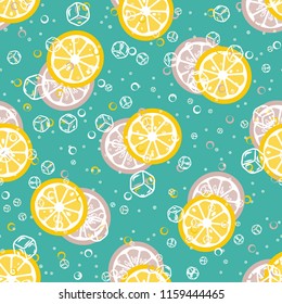 Fruit pattern with lemon and lime, ice cubes and mint leaves on a blue background. Cold cocktail with lemon. Freshness.