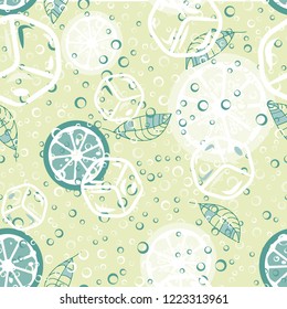 Fruit pattern with lemon and lime, ice cubes and mint leaves. Cold cocktail with lemon. Freshness.