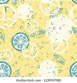Fruit pattern with lemon and lime, ice cubes and mint leaves. Cold cocktail with lemon. Freshness.