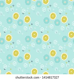 Fruit pattern with lemon and lime, ice cubes and mint leaves on a blue background. Cold cocktail with lemon. Freshness.