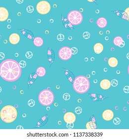 Fruit pattern with lemon and orange, ice cubes and mint leaves. Cold cocktail with lemon. Freshness.