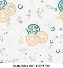 Fruit pattern with lemon and orange, ice cubes and mint leaves. Cold cocktail with lemon. Freshness.