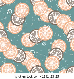 Fruit pattern with lemon and orange, ice cubes and mint leaves. Cold cocktail with lemon. Freshness.