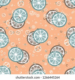 Fruit pattern with lemon and orange, ice cubes and mint leaves. Cold cocktail with lemon. Freshness.