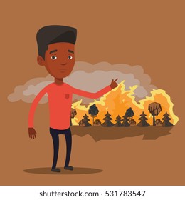 Frustrated man standing on the background of forest fire. An african-american man pointing at forest in fire. Concept of environmental destruction. Vector flat design illustration. Square layout.