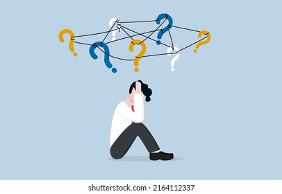 Frustration or depression from complex problems at work, stress or anxiety due to business difficulty concept. Stressed businessman holding his head and sitting on floor with messy question signs. - Shutterstock ID 2164112337