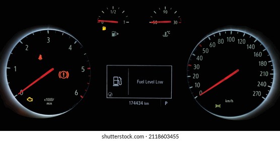 Fuel gauge with warning to indicate low fuel level. Indicator on car dashboard panel. Empty tank of gasoline. Yellow fuel check light. Car cluster with speedometer, tachometer. Vector illustration.