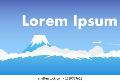 The Fuji mountain above the cloud level with airplane flying in the sky and copy space for text in blue color tone
