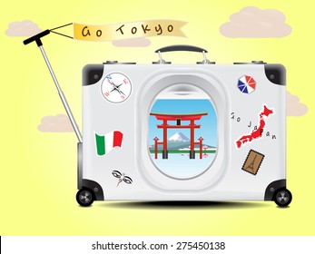 Fuji mountain and Tori red gate see through the air plane window on the gray suitcase baggage on yellow  background concept of travel tokyo Japan