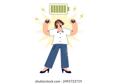 Full of energy woman showing biceps, standing near charged battery, for ready to work concept. Happy business girl is proud of energy received thanks to proper rest and balanced nutrition