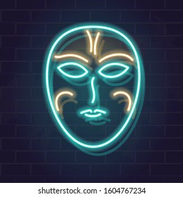 Full face neon canrival mask. Medivial face cover. Mystical glowing illustration. Illuminated image on dark brick wall background.