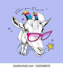 Fun Goat in a pink glasses, with a rainbow unicorn horns and with a star. Follow your Dreams - lettering quote. Humor card, t-shirt composition, hand drawn style print. Vector illustration.