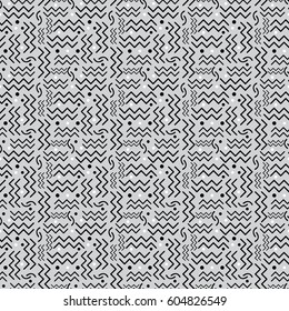 A funky seamless Memphis style design in black, white and gray. Vector EPS-10 file, transparency used. 