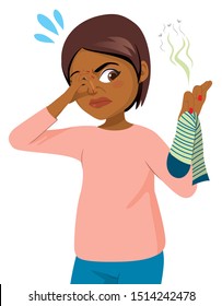 Funny action scene young black woman picking bad smelling sock