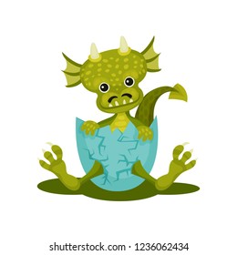 Funny baby dragon in blue broken egg shell. Green mythical monster with cute muzzle. Flat vector icon