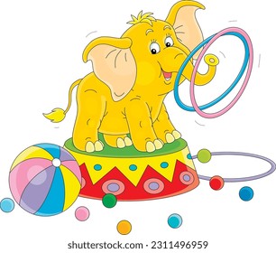 Funny baby elephant on a decorated pedestal performing tricks with colorful rings and balls in a merry circus show, vector cartoon illustration isolated on a white background