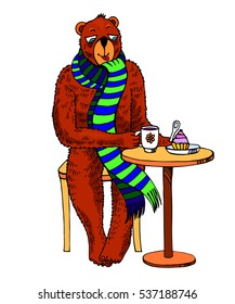 Funny bear wearing a scarf sits at a table in a cafe