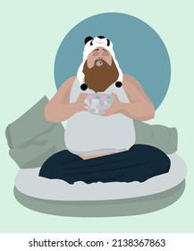 Funny bearded fat man in a panda hat eats a marshmallow